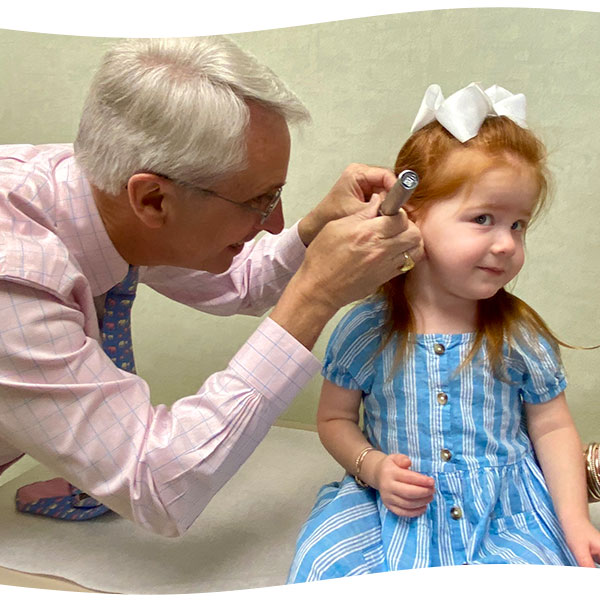 Allergist checking a patient's ear